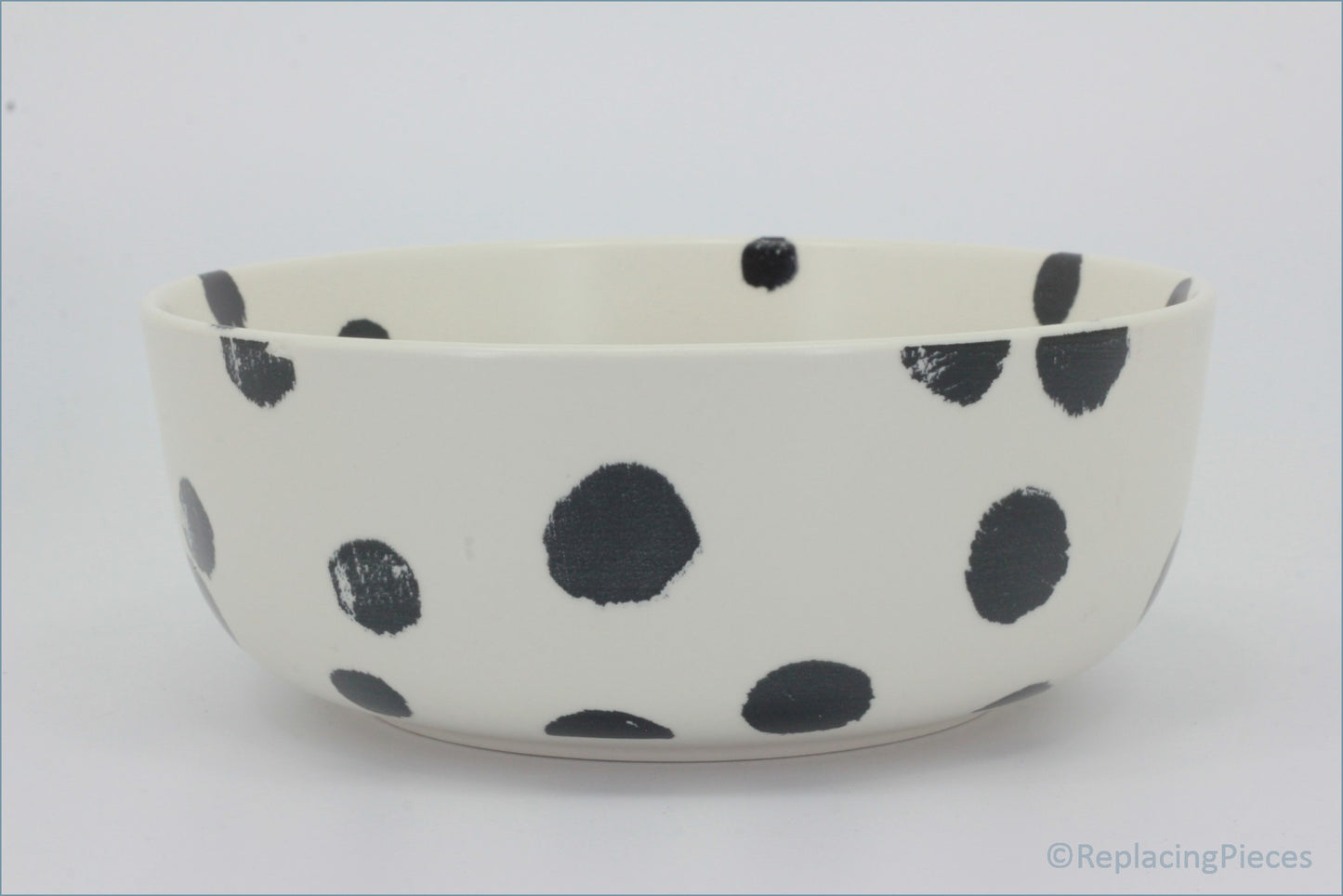 Habitat - Global - Cereal Bowl - White ceramic bowl with black polka dots on a white background