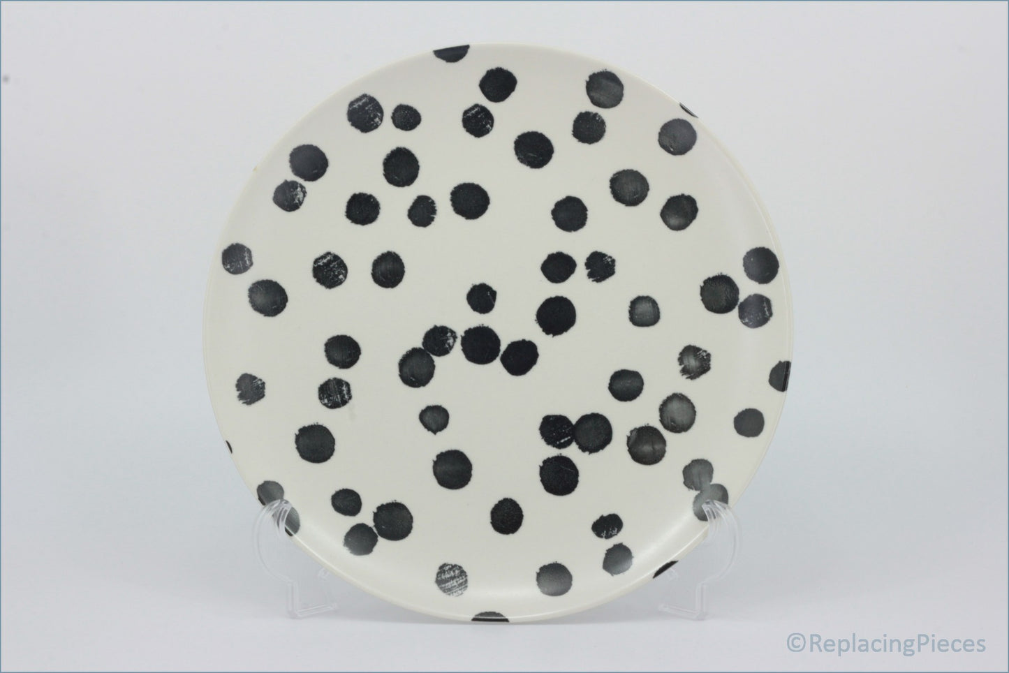Habitat - Global - Dinner Plate - Round ceramic plate with black polka dots on a white background