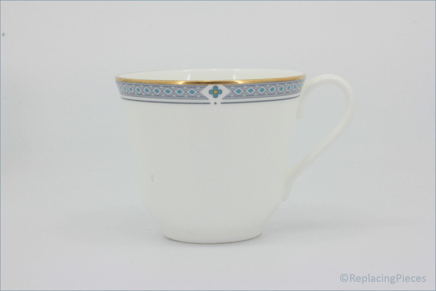 Marks & Spencer - Felsham - Teacup - White teacup with decorative blue and gold rim on a white background