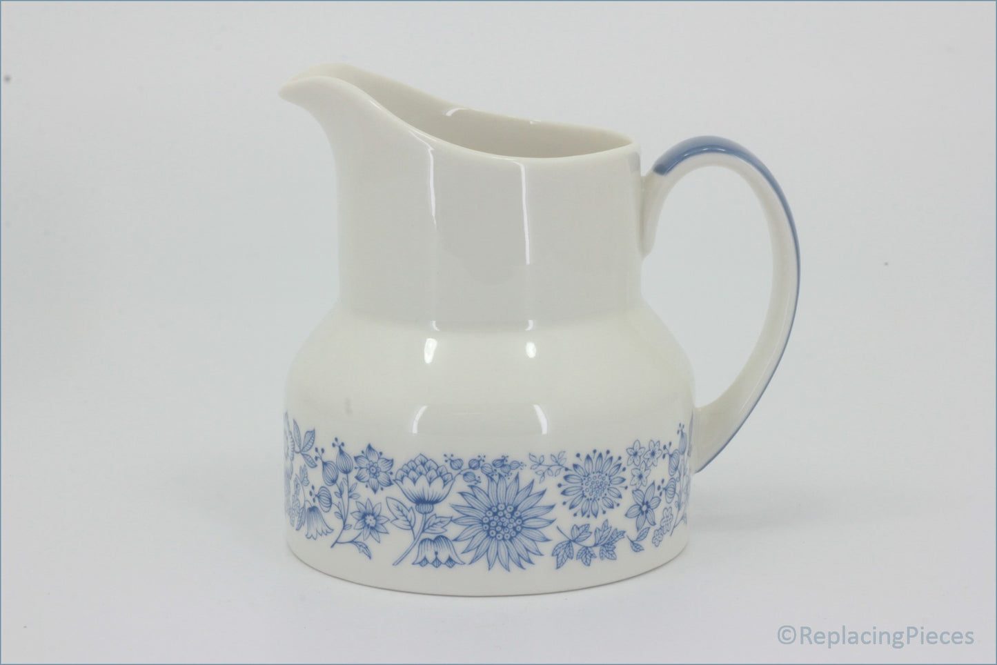 Royal Doulton - Cranbourne (TC1032) - Milk Jug - White ceramic pitcher with blue floral patterns on a white background