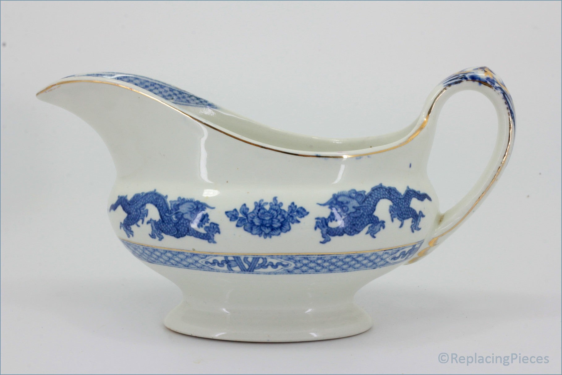 Booths - Blue Dragon - Gravy Boat - White ceramic gravy boat with blue floral and dragon design on a white background