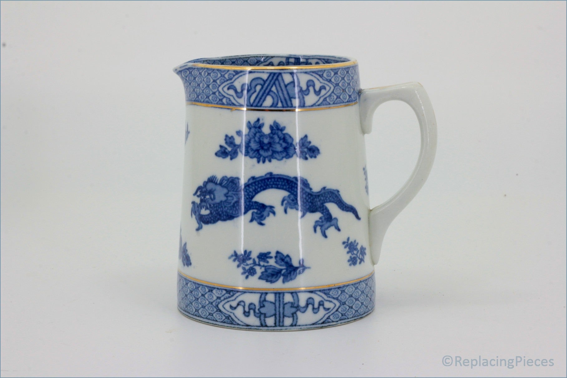 Booths - Blue Dragon - Milk Jug - Blue and white ceramic pitcher with decorative patterns on a white background