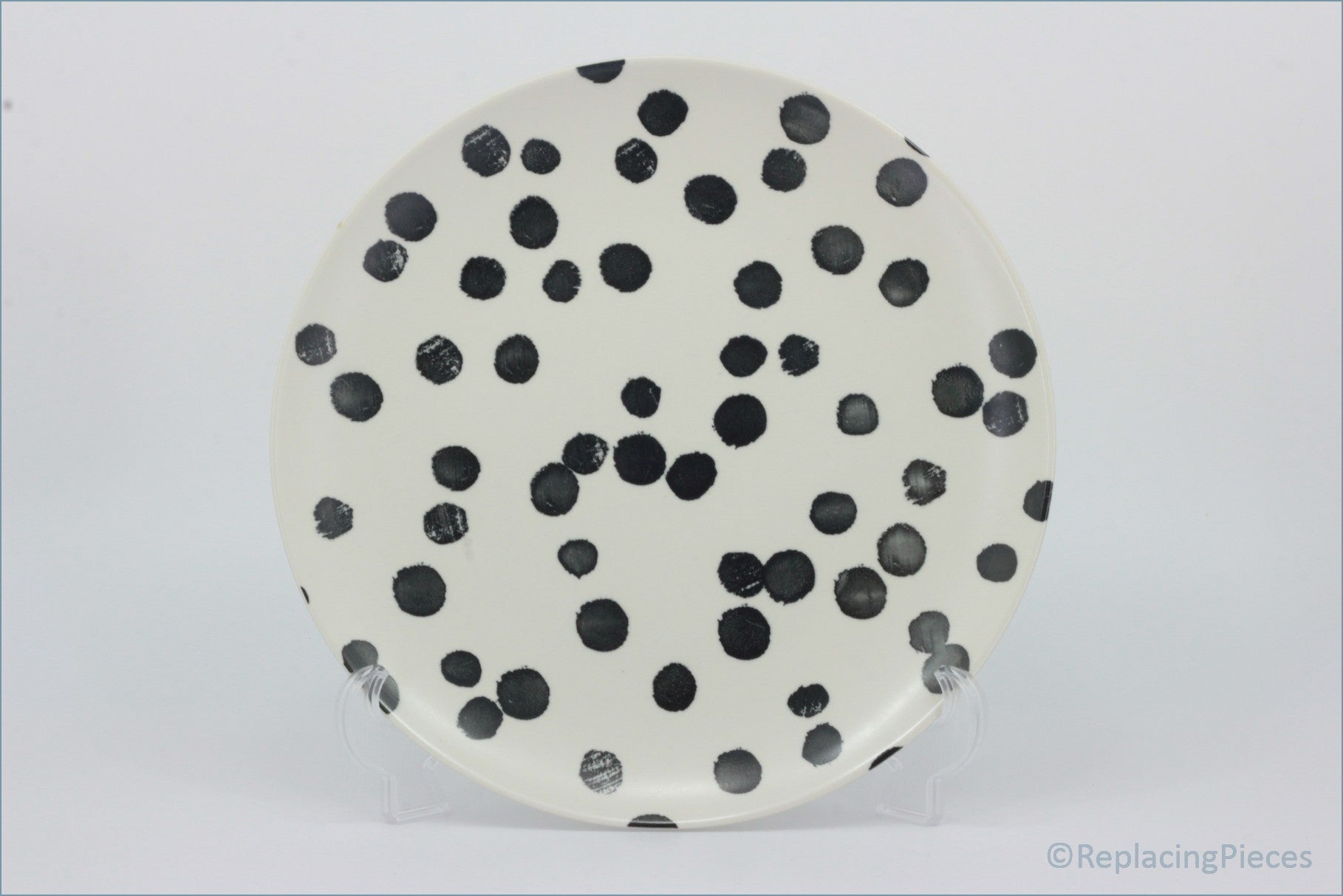 Habitat - Global - Dinner Plate - Round ceramic plate with black polka dots on a white background