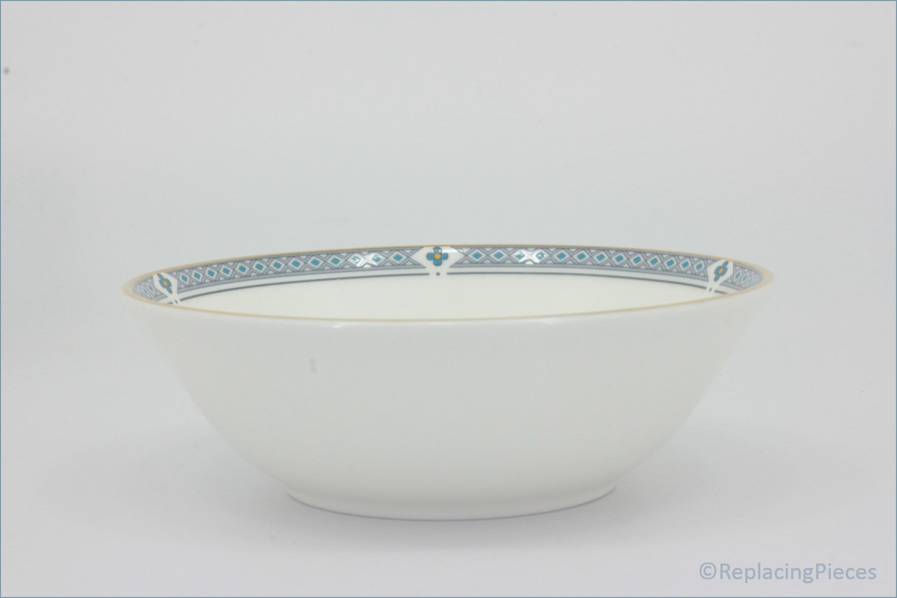 Marks & Spencer - Felsham - Cereal Bowl - White ceramic bowl with decorative blue rim on a light gray background