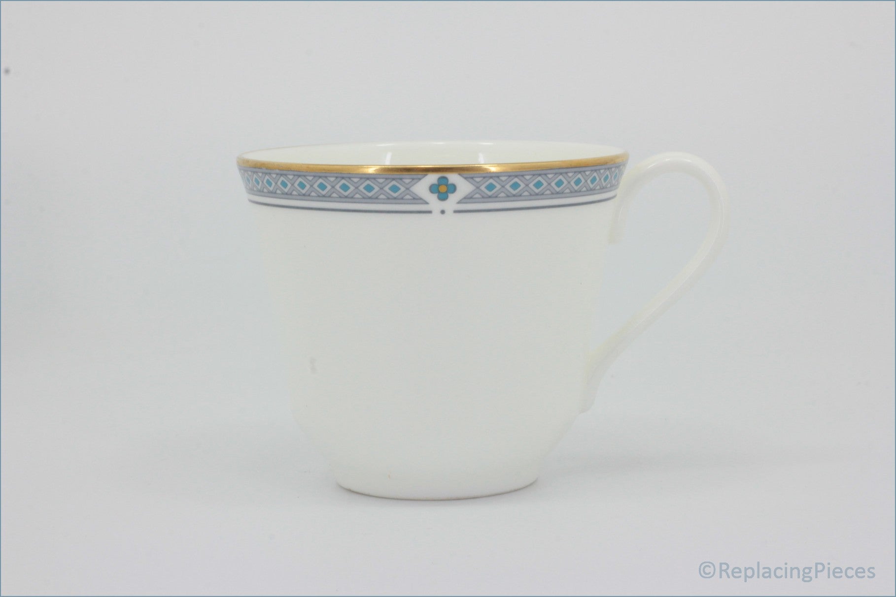 Marks & Spencer - Felsham - Teacup - White teacup with decorative blue and gold rim on a white background