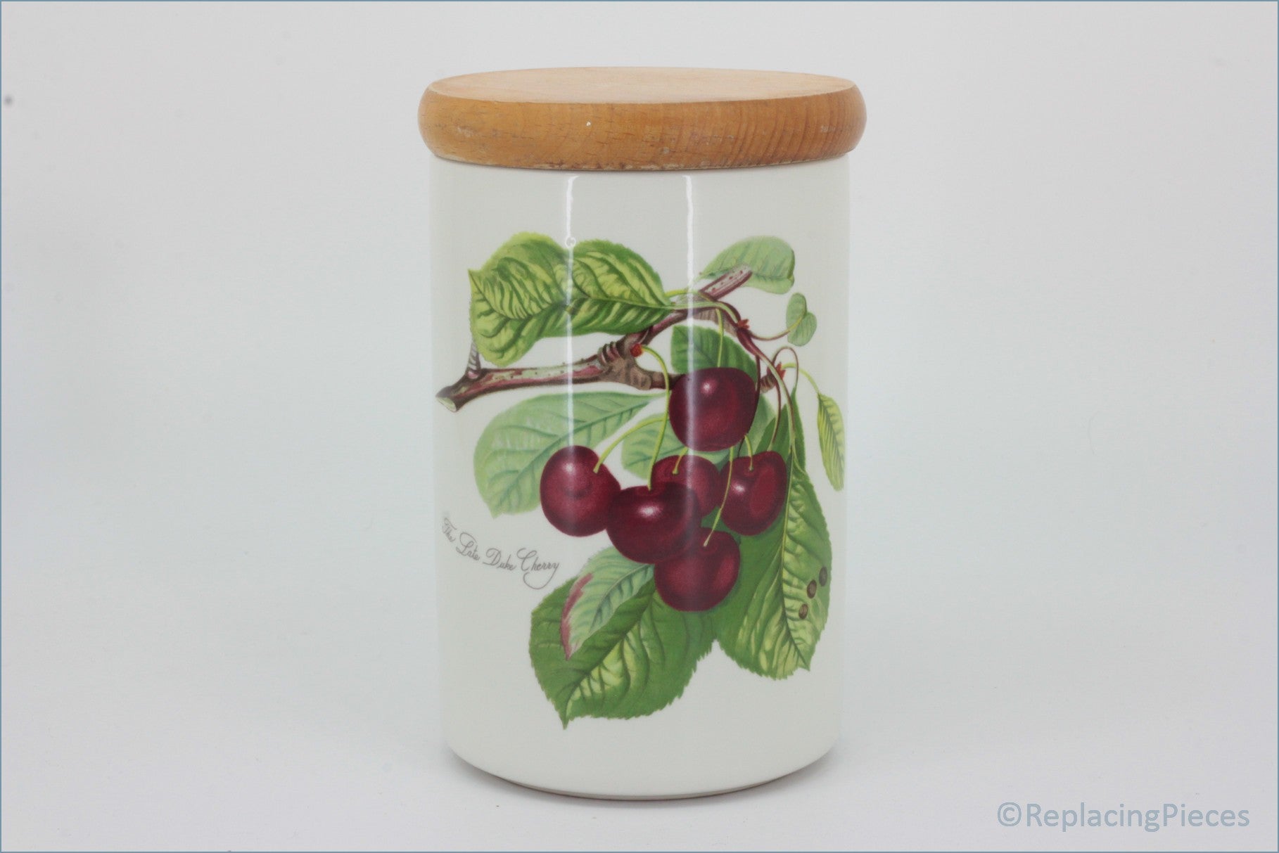 Portmeirion - Pomona - 7" Tall Storage Jar (Late Duke Cherry - no seal) - Decorative jar with cherry design and wooden lid on a white background