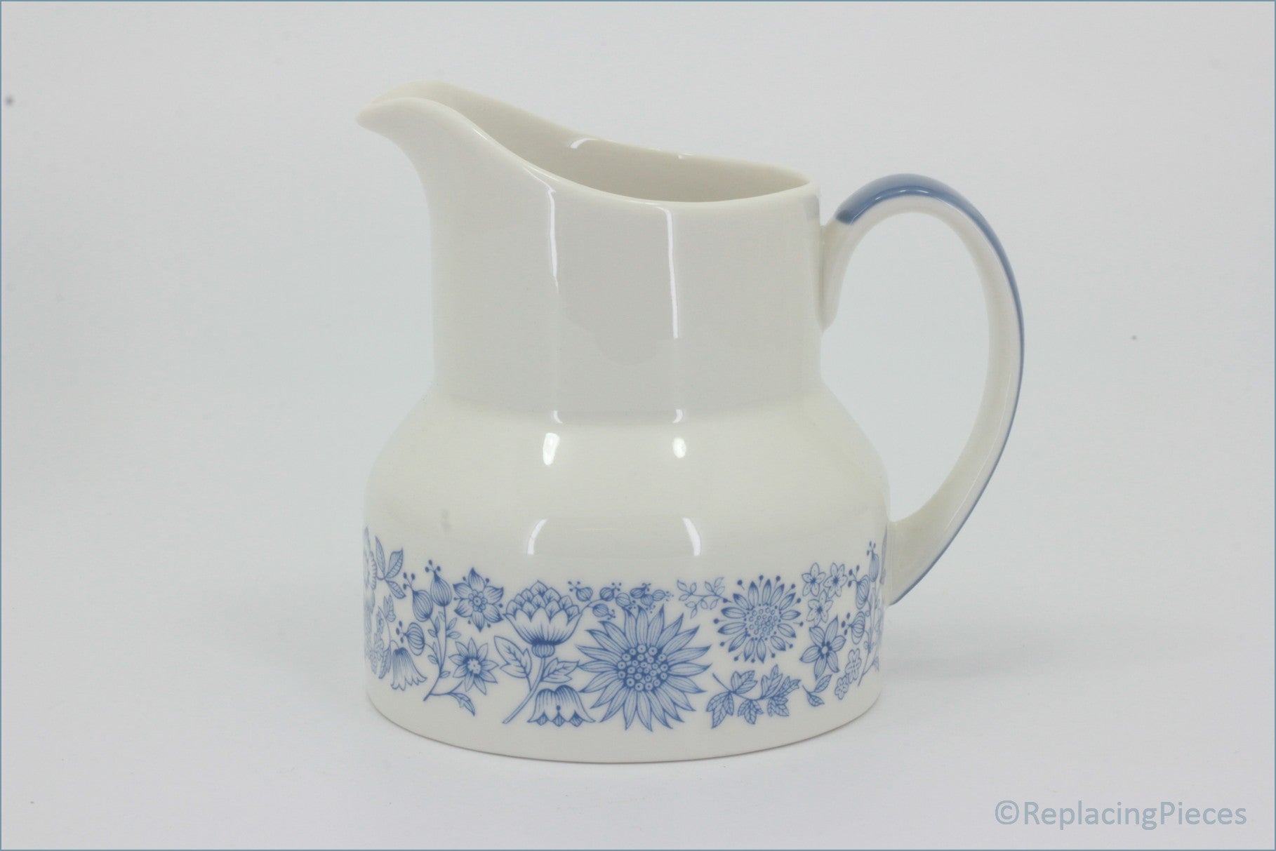 Royal Doulton - Cranbourne (TC1032) - Milk Jug - White ceramic pitcher with blue floral patterns on a white background