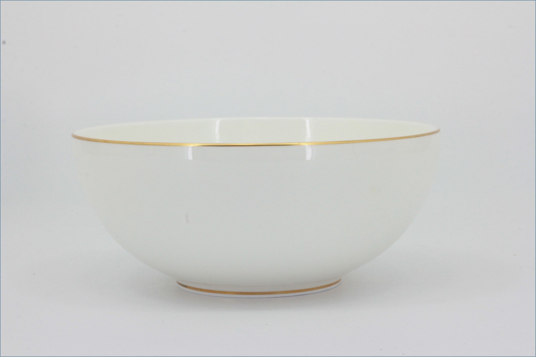White ceramic bowl with gold rim on a light gray background - Royal Doulton - Symmetry Gold - Cereal Bowl